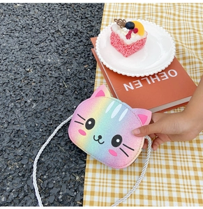 Close-up of glitter rainbow cat crossbody bag with silver twisted rope strap detail