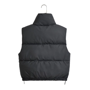 Detail of black cropped puffer vest featuring a stand collar and adjustable drawstring hem