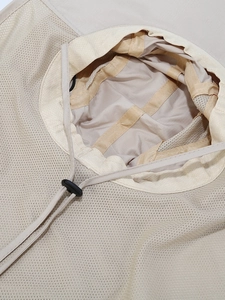 Beige outdoor sun hat with breathable mesh lining and adjustable chin strap detail