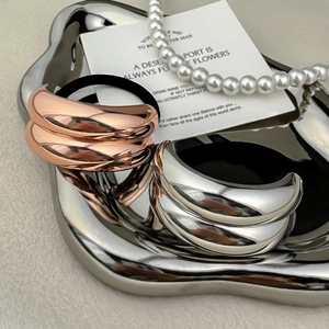 Luxury rose gold and silver metallic elastic hair ties on an aesthetic metal tray