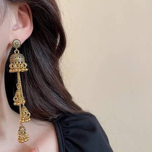 Vintage gold layered Jhumka earrings with intricate bell shapes and floral details