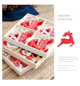 Detailed view of red wooden Christmas ornaments with reindeer and Santa designs in a tray