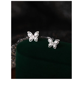Macro view of butterfly earrings featuring silver metal and sparkling zircon stones