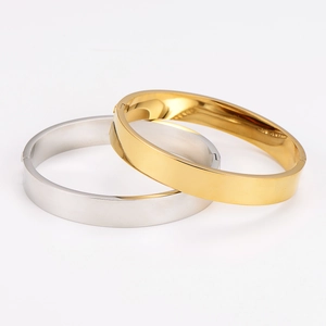 Polished gold and silver stainless steel bangles with smooth finish and buckle detail