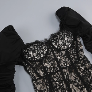Detail view of black lace bodice with sweetheart neckline and puff sleeves
