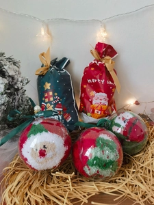 Close-up of festive Christmas socks in gift balls with themed drawstring bags and LED lights