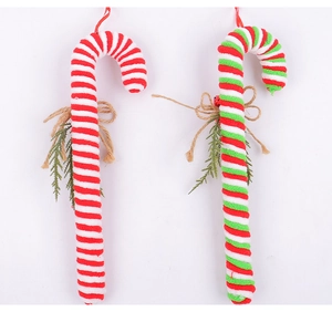 Detail of red and white striped candy cane ornaments with pine needles and burlap bows