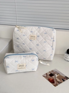 Set of two floral quilted cosmetic bags with blue bows and large storage capacity