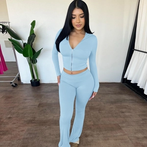 Close-up of light blue zip-up hoodie and high-waisted flared trousers sports set