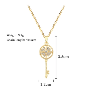 Detailed view of golden spinning key necklace with clover rhinestone pendant specifications