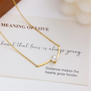 Elegant gold stainless steel necklace with round pearl pendant and arched bar detail