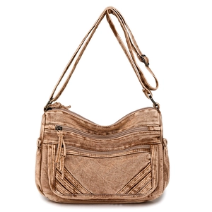 Detailed view of the multi-pocket vintage brown canvas bag with copper zippers