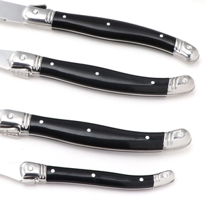 Set of 4 stainless steel steak knives with black ABS handles and white dot patterns