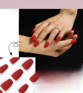Macro detail of matte red short coffin press-on nails with frosted texture finish