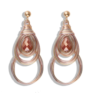 Macro detail of Bohemian wire-wrapped heart earrings with amber teardrop gemstones