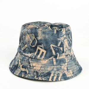 Detail of blue denim bucket hat featuring vintage letter print and durable fabric texture
