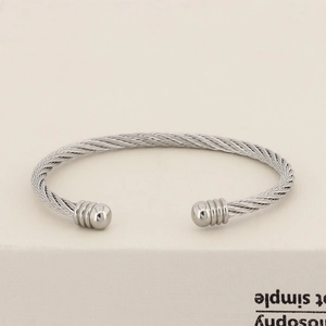Close-up of a silver twisted cable wire bracelet with smooth polished spherical ends