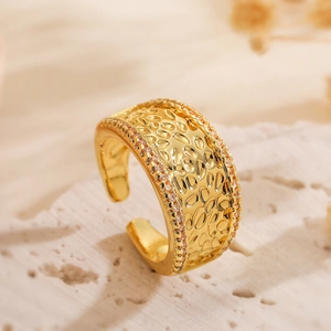 Hammered gold wide open ring with zircon pavé edges in a 45-degree studio shot