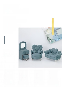 Detailed view of grey-blue velvet sofa shaped jewelry box with functional mirrors