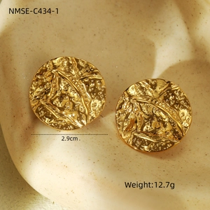 Macro shot of 2.9cm gold hammered finish stainless steel round studs with lava texture