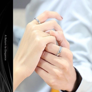 Close-up of a 4mm polished silver stainless steel ring worn on a finger