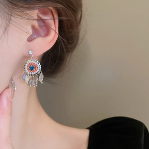 Vintage floral earrings with colorful crystal tassels shown on a model profile