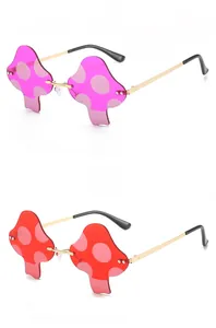 Detail display of mushroom shaped rimless sunglasses in pink and red with gold metal frame