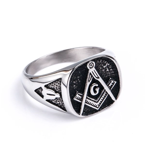 Macro shot of silver and black stainless steel Freemasonry ring with G symbol engraving