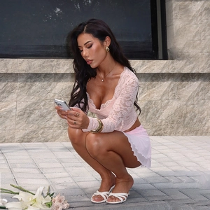 Detailed texture of pink long sleeve lace crop top with elegant floral mesh patterns