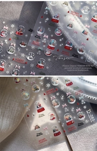 Macro shot of 3D Christmas nail stickers with Santa Claus and snowflake embossed details