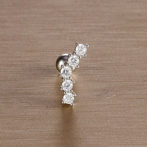 Macro shot of silver leaf cartilage stud with five sparkling cubic zirconia stones