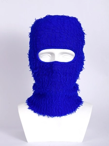 Detail of blue shaggy knitted balaclava showing fluffy fringe texture and single eye hole