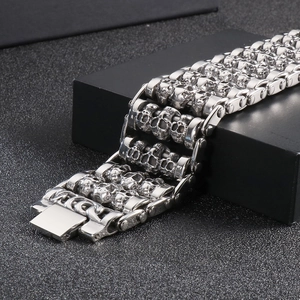 Detailed view of silver skull punk bracelet with triple row embossing on a display box