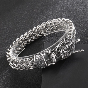 Close-up of retro stainless steel dragon head clasp on textured wheat chain bracelet