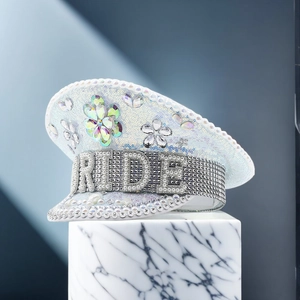 Detail of white bridal captain hat with BRIDE pearl embroidery and colorful rhinestone flowers