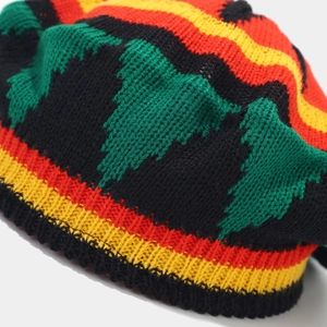 Macro shot of colorful Rasta style knit beret showing textured yarn details and stitching