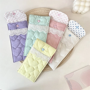 Detail of quilted heart sunglasses pouches with lace trim and heart-shaped snap buttons