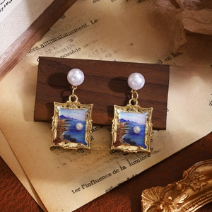 Detail of vintage French floral earrings with blue oil painting frame and pearl drop