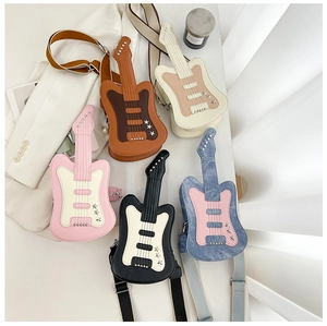 Detailed flat lay of guitar-shaped crossbody bags with star studs and chain straps