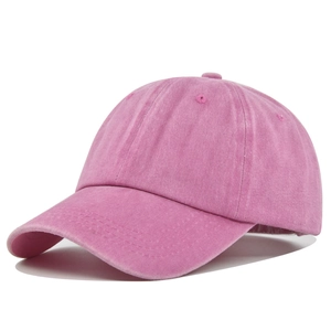 Detail view of pink washed cotton baseball cap texture and stitching on plain crown