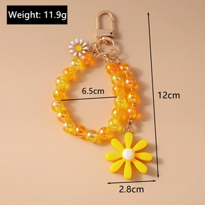 Detail view of yellow beaded keychain with daisy pendant showing 12cm total length
