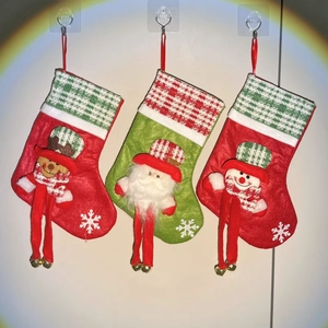 Detailed view of three 3D Christmas stockings featuring reindeer, Santa, and snowman figures