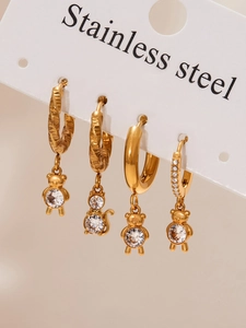Detailed close-up of 18k gold plated bear and cat earrings with sparkling cubic zirconia