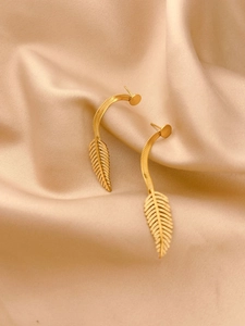 Elegant gold feather tassel earrings on satin fabric, luxury leaf design drop jewelry