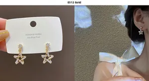 Detail view of gold star earrings with cubic zirconia and 925 silver needle on model