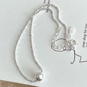 Minimalist S925 sterling silver bead anklet with polished central sphere on white card