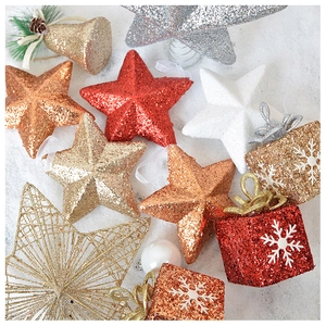 Detailed view of colorful glitter star, bell and snowflake Christmas tree ornaments