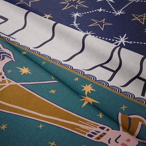 Detailed macro view of soft velvet tapestry fabric with zodiac and star patterns