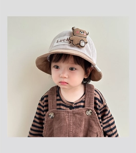 Detail of baby corduroy bucket hat featuring 3D teddy bear ears and Lucky patch