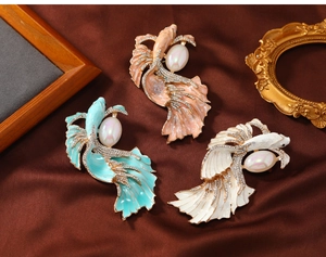 Detailed macro view of vintage enamel goldfish brooches with pearls and crystals